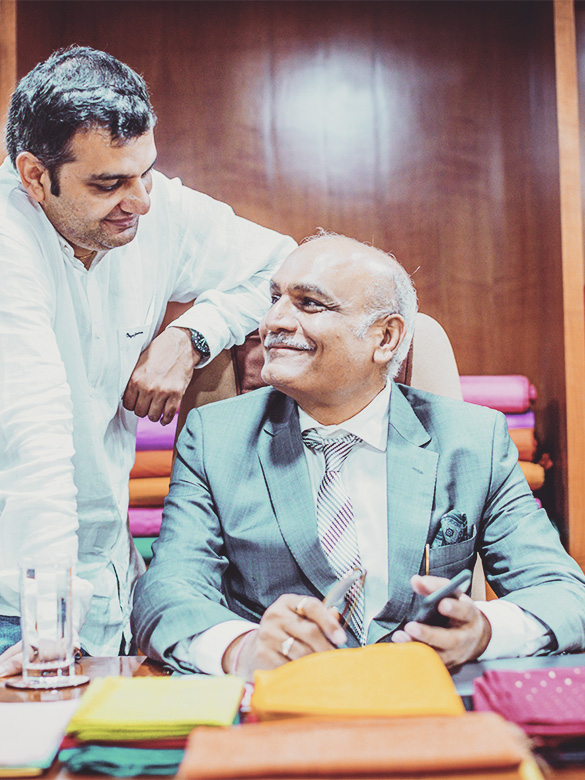 Family Business, Empire, Textile Industry - Textile Business Owner with his Son looking at each other