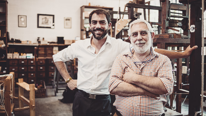 Father and son in their artisanal handicraft traditional textile factory