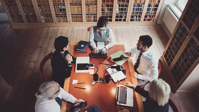 High angle view of lawyers researching at table in board room